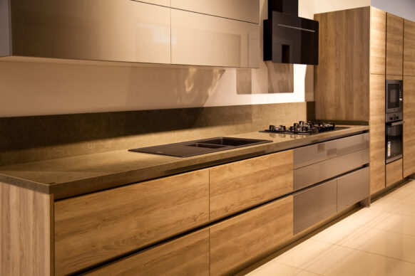 A modern kitchen with light wood cabinetry