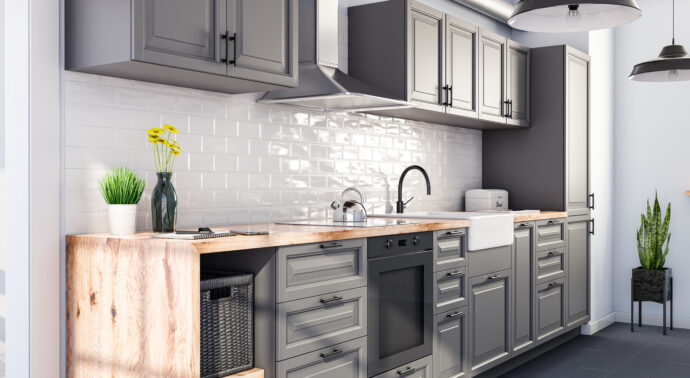 A light gray kitchen with a decorative, whit backsplash