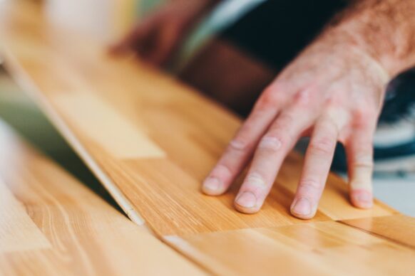 A man installs a kitchen floor.